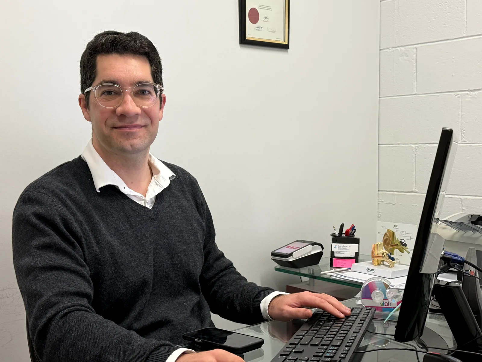 Lachlan Smith, senior clinical audiologist, at his desk